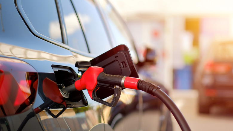 Gas pump refueling car with gas lid open