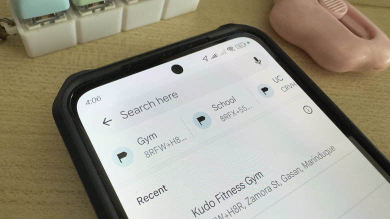Phone showing Google Maps search bar with labels
