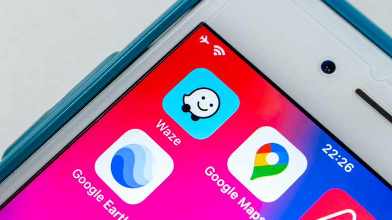 Google Maps and Waze icons on a smartphone screen, with Google Earth's icon on the bottom