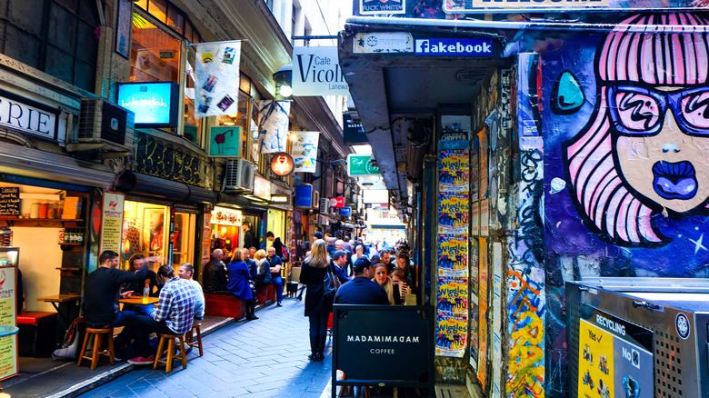 A busy street with lots of coffee shops.