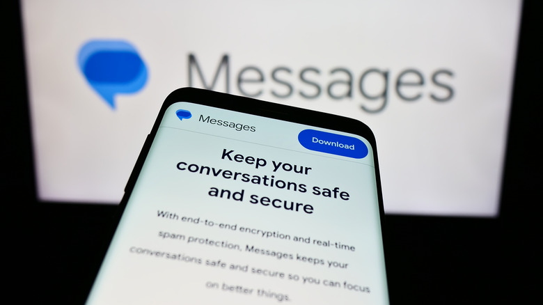 Google Messages open on phone with logo in background.
