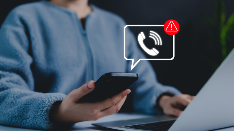 person holding smartphone with message / call icon hovering above phone with scam notification concept