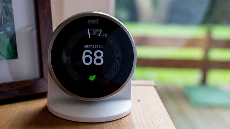 a Google Nest Hub smart thermostat showing the temperature at 68