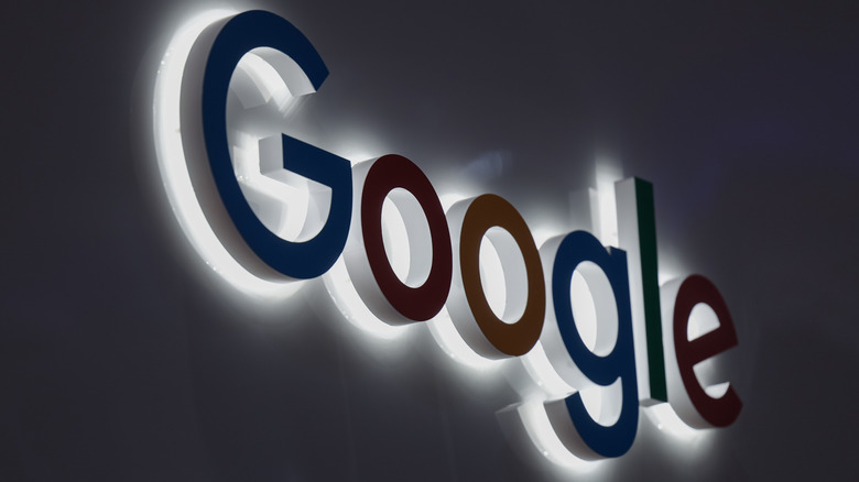 A Google logo sign at night.