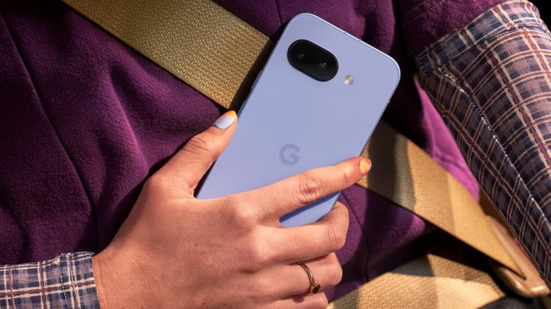An individual holding the Iris-colored Google Pixel 9a