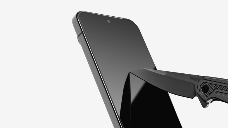 Dbrand Prism 2.0 Screen Protector on a Pixel phone being scratched by a knife