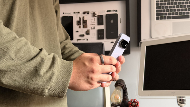 Side-on shot of somebody holding and using the Pixel 11