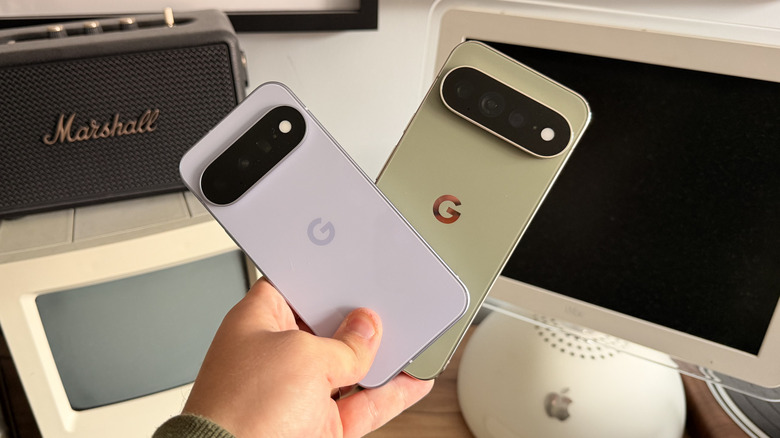 Pixel 11 and 11 Pro XL being held in the same hand at angles