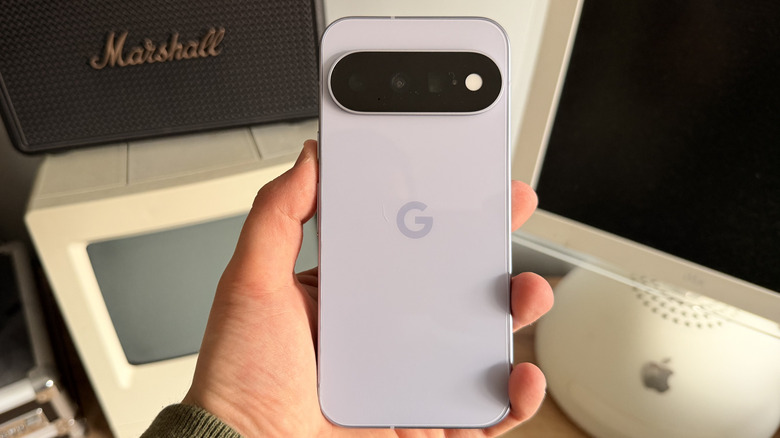 Pixel 11 in Frost color being held in hand