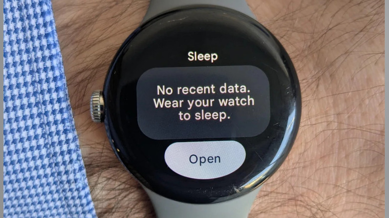A silver banded Google Pixel Watch 2 shows a "No recent data. Wear your watch to sleep" symbol on its watch face.