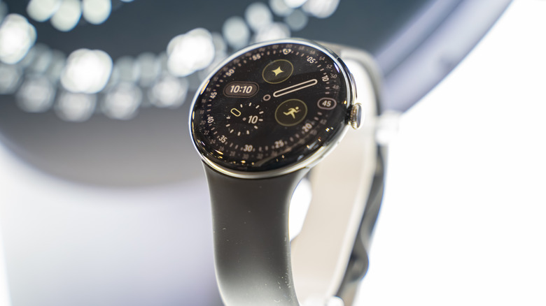 A Google Pixel Watch on display showcases a sleek black watch face.