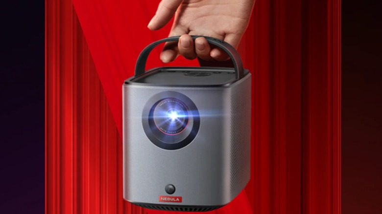 Someone holding a Nebula Mars 3 Air projector