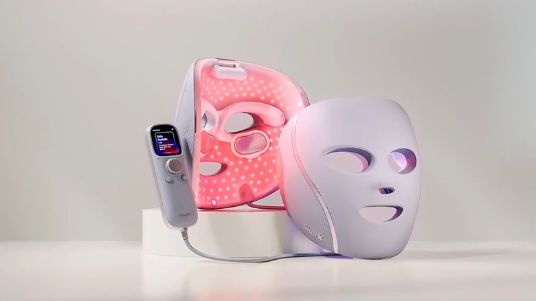 A Shark CryoGlow LED Mask with its remote control