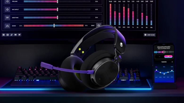 A Skullcandy Crusher PLYR 720 headset with a keyboard, phone, and monitor