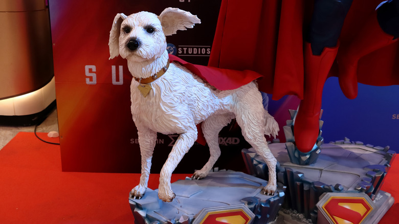 Statue of Krypto next to Superman in a movie theater lobby