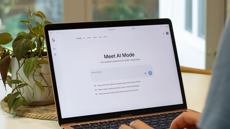 A person using Google's AI Mode on a laptop.
