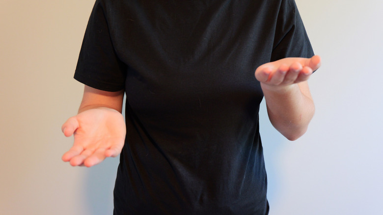 A girl demonstrating the "6-7" hand gesture.