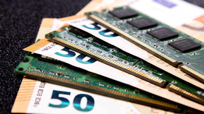 Stack of money in with several sticks of RAM, concept about ram prices