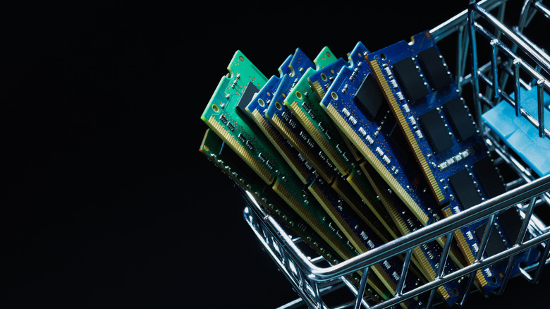 Shopping cart with ram sticks in it on black background