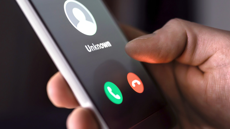 Smartphone showing an unknown caller with answer and decline buttons