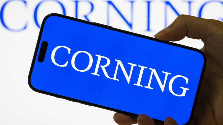 A smartphone with the Corning logo on it.