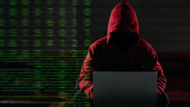 concept of hacker using laptop to hack into AI code