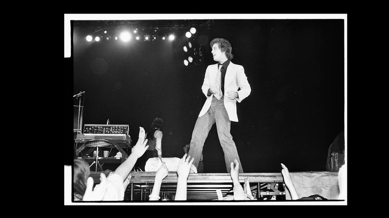 Billy Joel poses onstage in front of fans