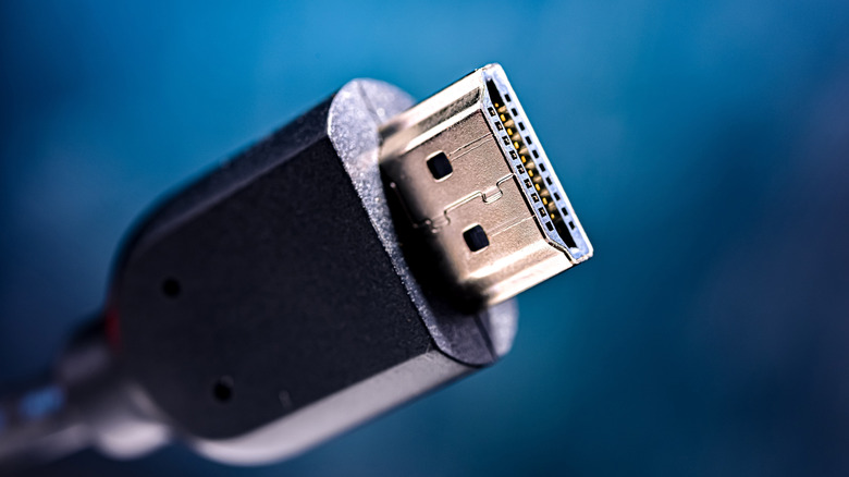 An HDMI cable is pictured against a blue backdrop.