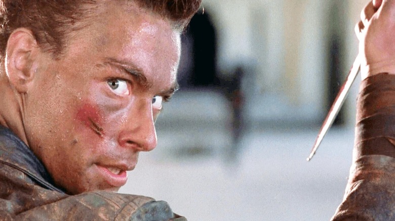 Jean-Claude Van Damme holding a knife in Cyborg