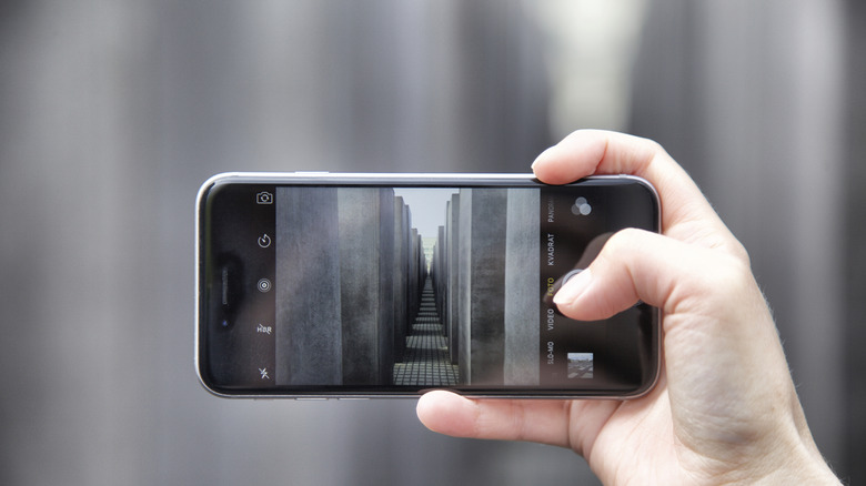 A person taking a photo with an iPhone using the camera app