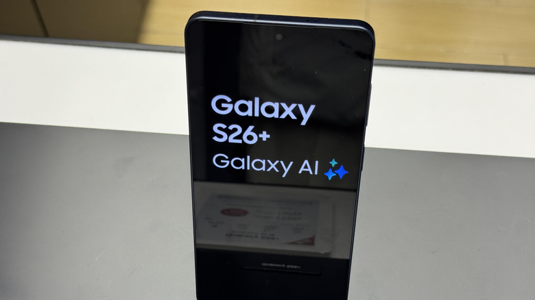 Samsung Galaxy S26+ on display on retail shelf with Galaxy AI logo visible.