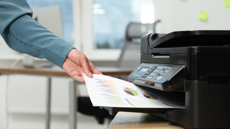 a woman having a printer print a test page