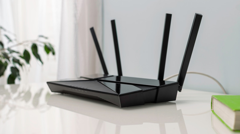 A Wi-Fi router with four antennas on white table