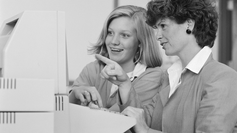 Teacher with student at computer
