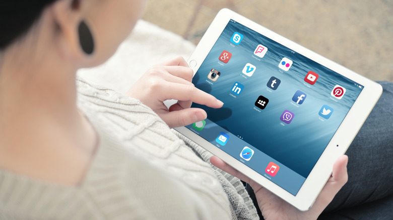 A person sitting down with their iPad Air 2.
