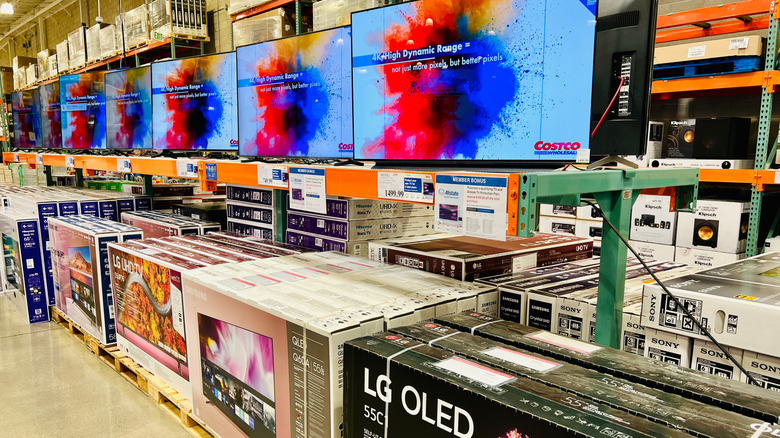 LG OLED TVs arranged in a row on display in a Costco