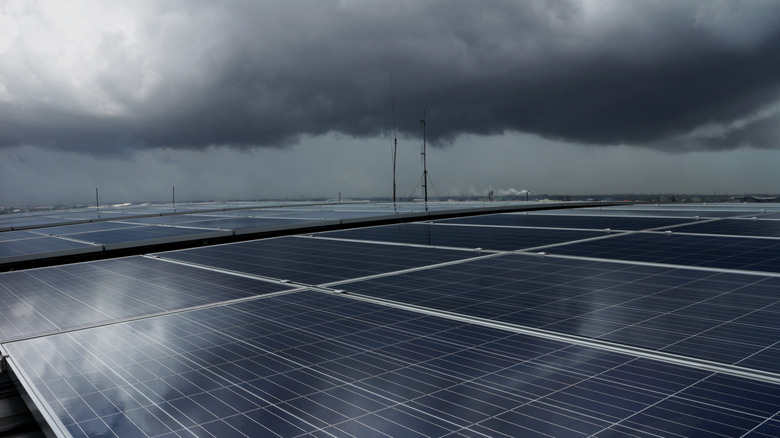 A solar panel array under heavy storm clouds