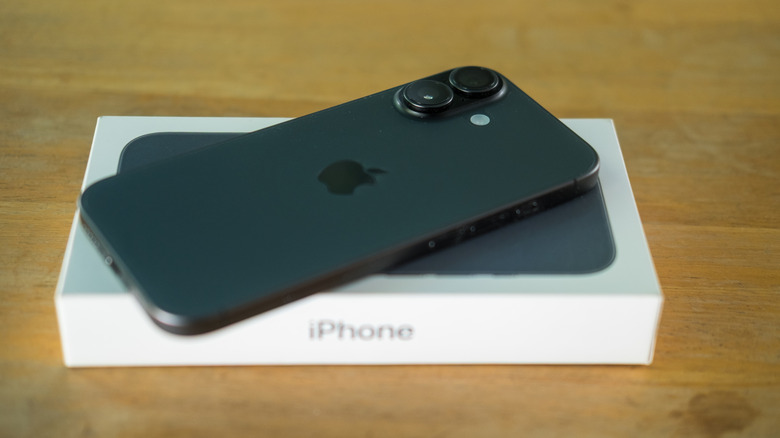 The iPhone 17 on top of its retail box.
