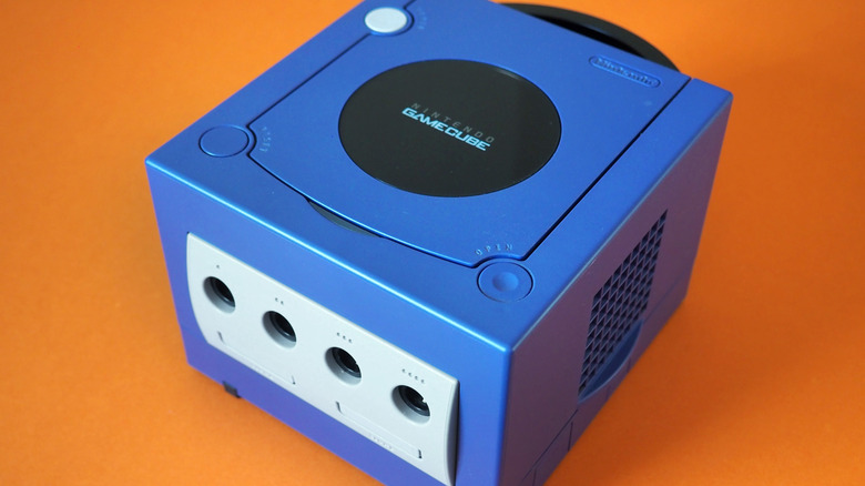 Indigo edition of the Nintendo GameCube on an orange background