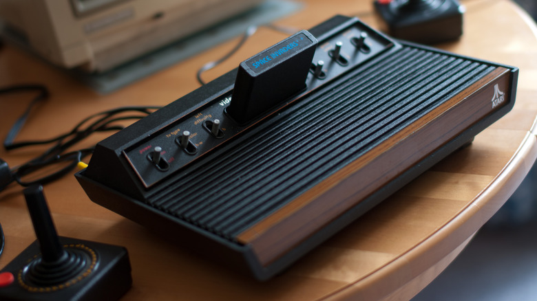 Atari 2600 console sitting on a wooden table.