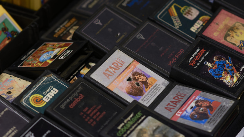 Many Atari 2600 cartridges stacked on top of one another.