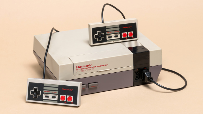 The original Nintendo Entertainment System against a beige backdrop