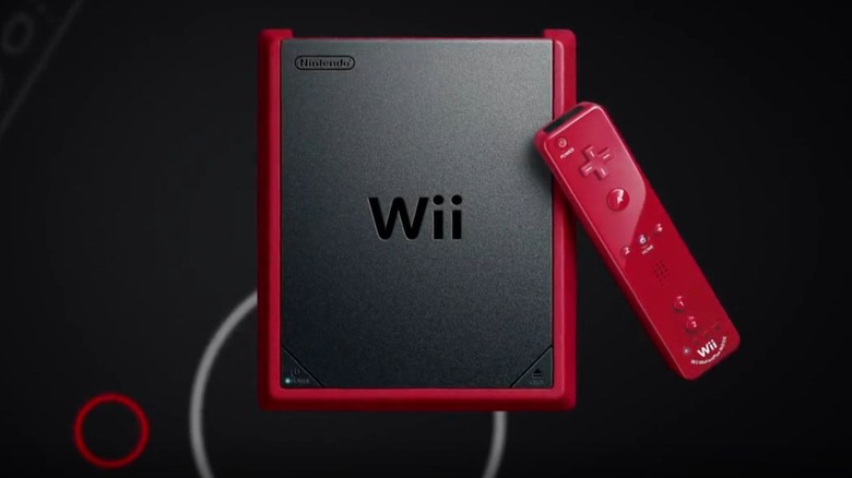 Wii Mini, a black rectangular console with a red border, with a red Wii Remote on a black background
