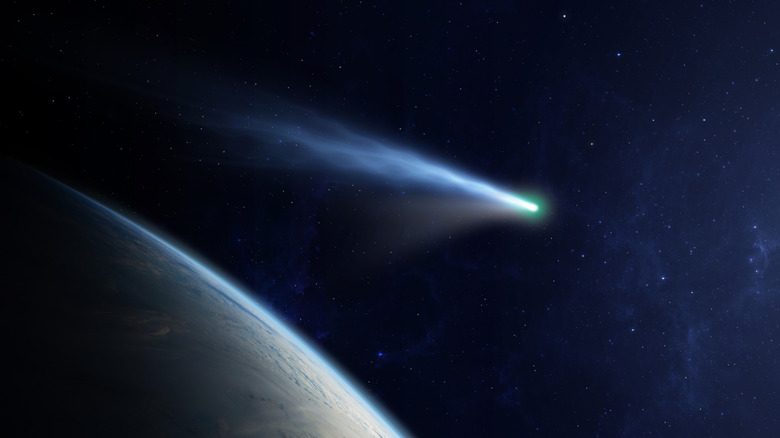 The edge of a planet with an artistic depiction of a comet or ion spacecraft going by through space