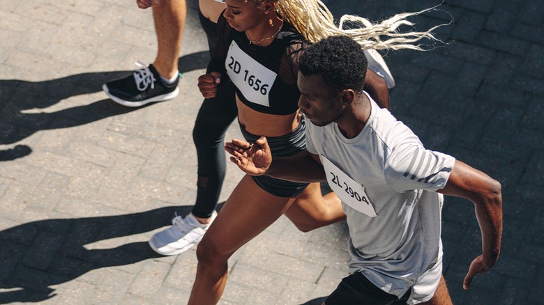 People running a marathon, with one wearing the Samsung Galaxy Ring