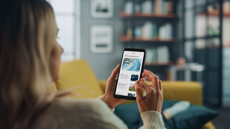 Woman reading news on smartphone
