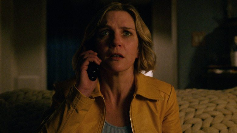 Actress Rhea Seehorn holds a phone to her ear in a scene from Pluribus