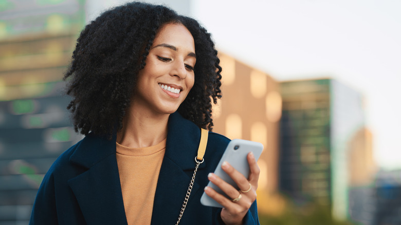 A woman looking at her Android phone