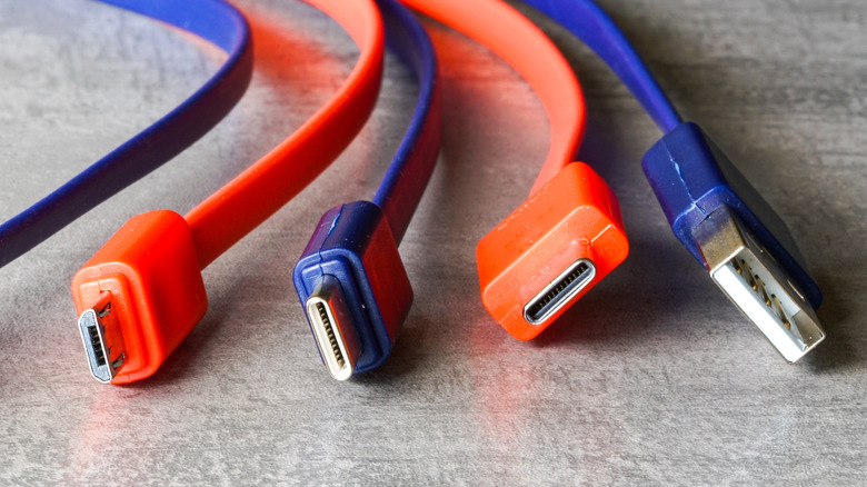 Close-up of red and blue USB Type-A, Micro-USB, and USB-C charging cables