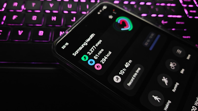 Smartphone on top of a keyboard, showing Samsung Health app open